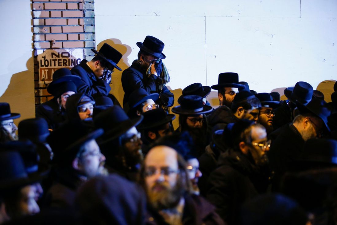 Orthodox Jewish men mourn during the funeral service of Mindel Ferencz who was killed in a kosher market that was the site of a gun battle in Jersey City, N.J.